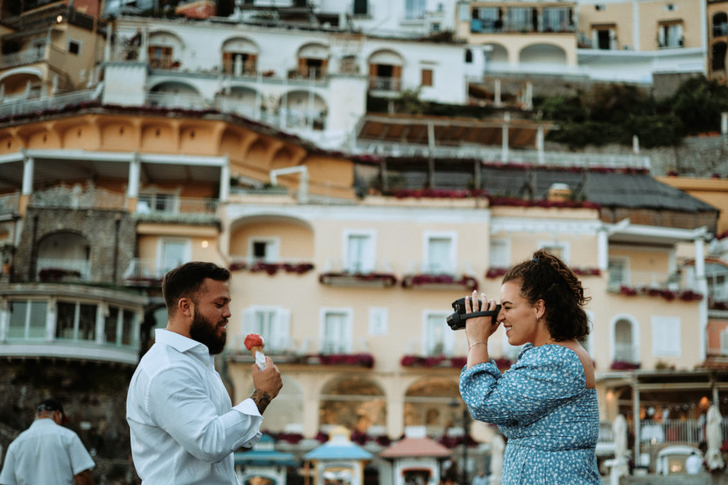 positano engagement photo inspo with gelato and film cameras as the intro photo to a blog about a creating a timeline for booking wedding vendors