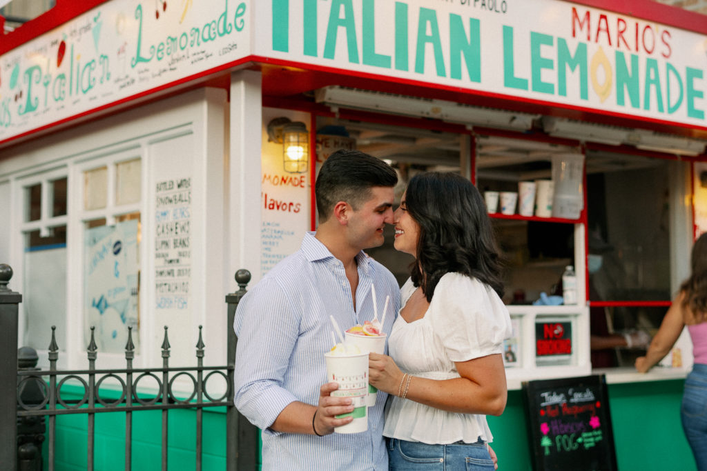 a couple taking their engagement photos at marios italian lemonade stand in chicago