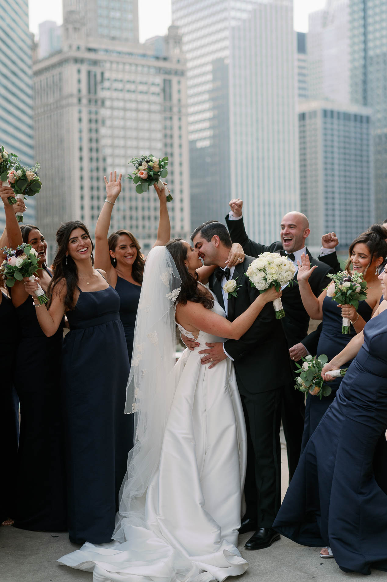 a wedding party celebrating on the chicago river walk
