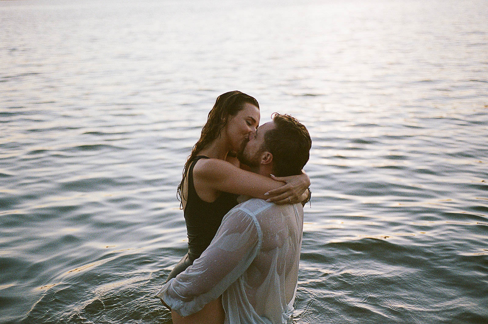 a film photo of a couple in a lake during the engagement session in chicago illinois