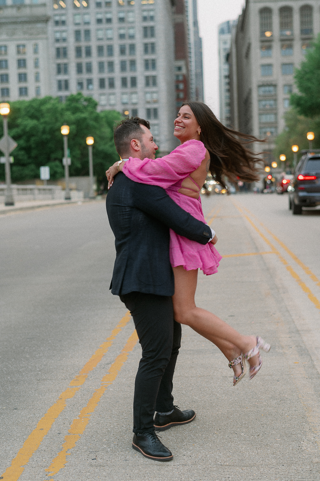 Couple dancing on michigan avenue at the art institute of chicago for their engagement photos